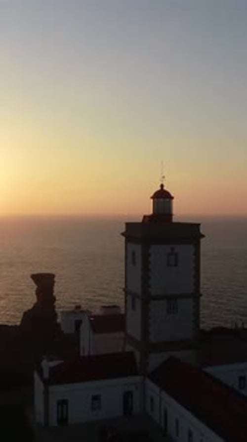 Vertical Video of Lighthouse at Sunset. Cabo Carvoeiro, Peniche, Portugal Aerial View
