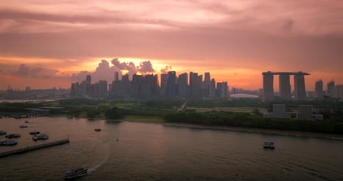 Iconic Marina Bay Sands hotel and Singapore skyline backlit by vibrant sunset