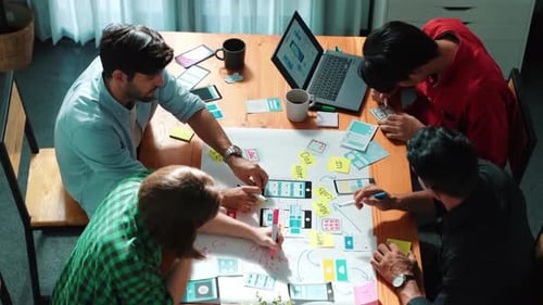 Creative Team Brainstorming App Design at a Table