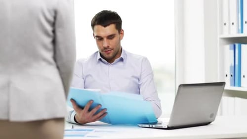 Business, People, Paperwork and Technology Concept - Secretary or Assistant and Businessman