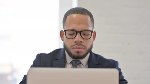 Close Up of African Businessman Working on Laptop