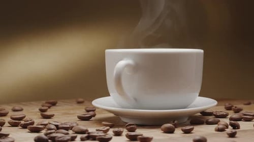 Steaming Coffee Cup with Coffee Beans on Wooden Table