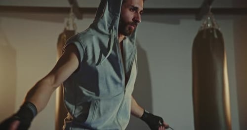 Active Man Jumping Skipping Rope in Sport Club