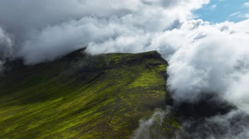 Clouds Above Green Hills Mountain Range Aerial View