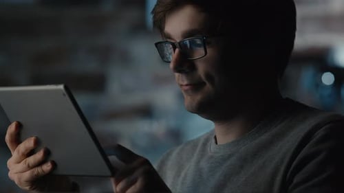 Man Using Tablet PC in Coffee Shop