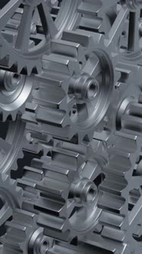 Intricate Array of Rotating Interlocking Metal Gears in CloseUp View
