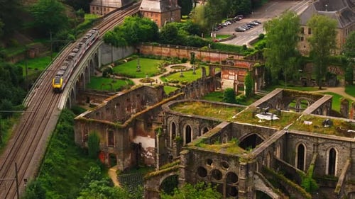 Aerial View of a Train Running Near the Ruins of Villers Abbey in Belgium The Abbey is a Popular