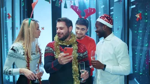 Friends Celebrating Christmas in Decorated Office Space