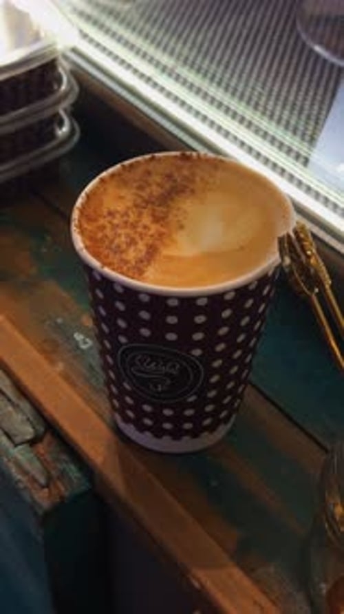 Coffee Art Closeup Closeup of Latte with Cinnamon Pattern on Weathered Wooden Surface in Dim
