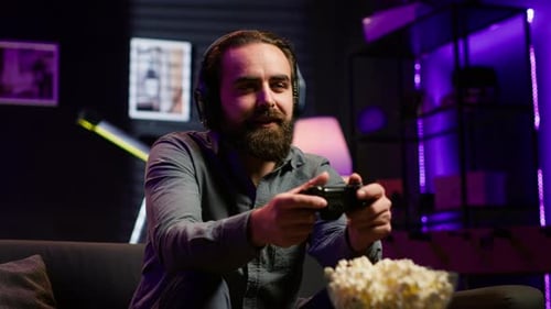 Man playing video game at home