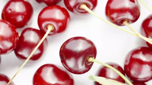 Close Up of Red Cherries on White Surface