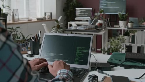 Unrecognizable Programmer Writing Code on Laptop in IT Startup Office