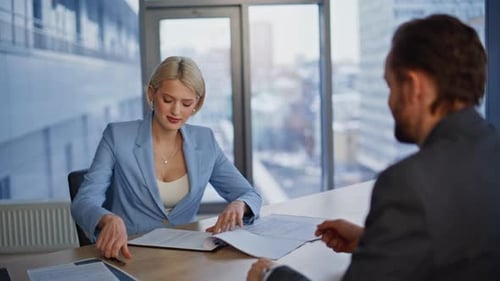 Business Meeting and Contract Signing in Modern Office