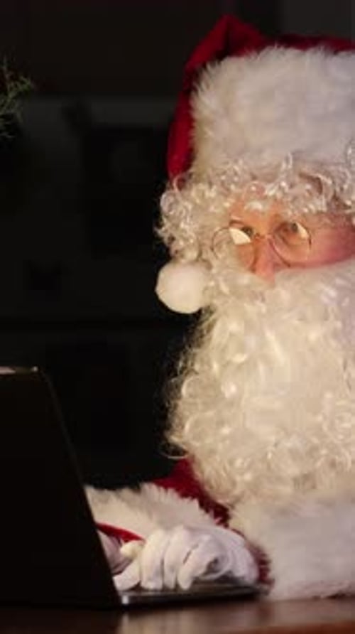 Santa Claus Using Laptop Computer for Christmas Shopping
