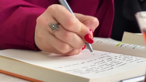 Close Up of Hand Writing in Journal