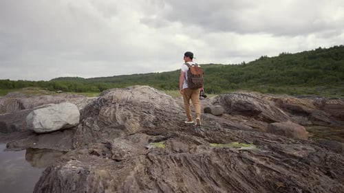 The Call of Adventure Resonates in Norway's Wild Nature As a Lone Traveler Explores the Mountains