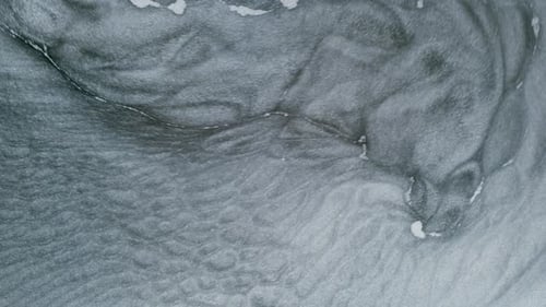 Swirling Silver and Gray Paint Creates Abstract Patterns