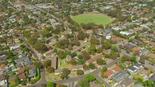 Aerial view of a suburban housing area, flying to the right and slowly panning.