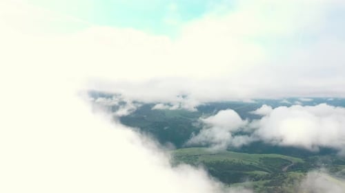 Aerial footage of drone flying through and emerging from clouds in the sky. Southern Oregon. USA