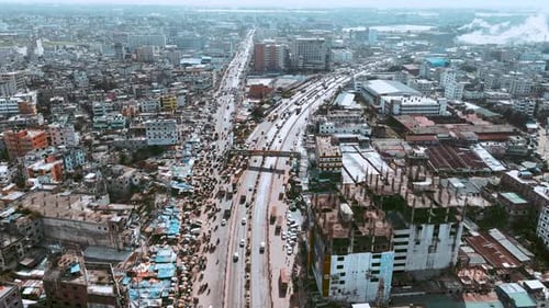 Aerial shot of a busy road where vehicles are passing in Dhaka, Bangladesh,