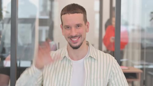 Portrait of Creative Young Man Waving Hand to Say Hello