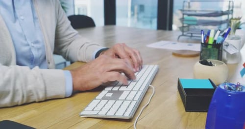 4k video footage of an unrecognizable businessman working on his computer in the office