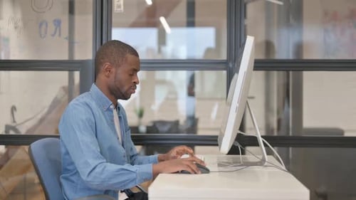 Man Working at Computer in Modern Office