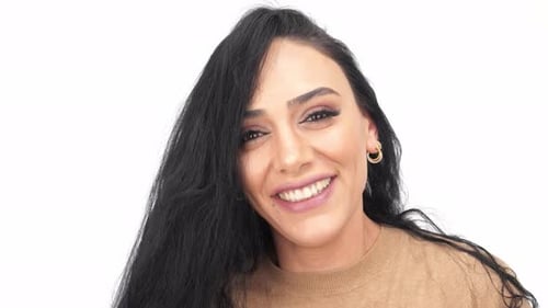 Elegant Woman Smiles and Runs Fingers Through Hair