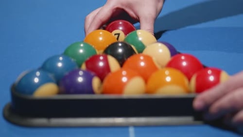 After placing the balls hands remove the black snooker triangle to start the game