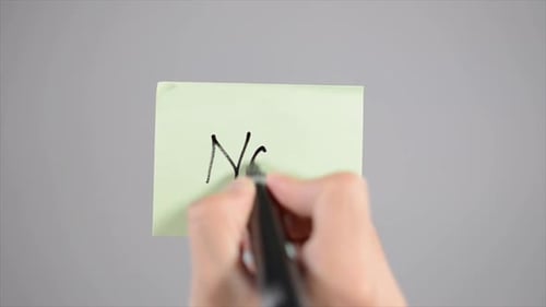Writing 'No!' on Light Green Memo Note