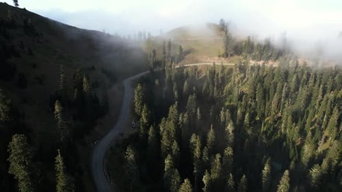 Foggy mountain road and sunset light
