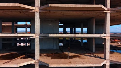 Front view of multi story unfinished concrete building frame.