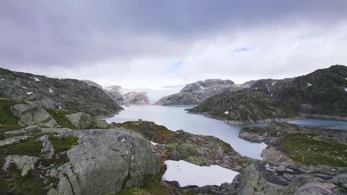 Norwegian Lake Surrounded By Rocky Wilderness And Rugged Terrain