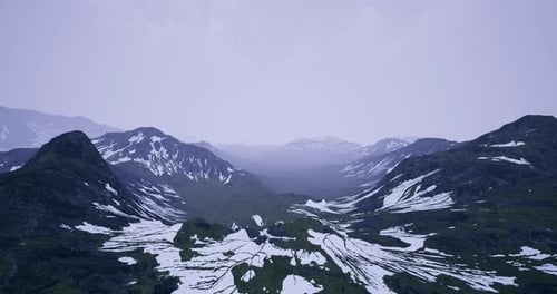 Majestic Mountain Landscape with Snow and Green Valleys During Twilight