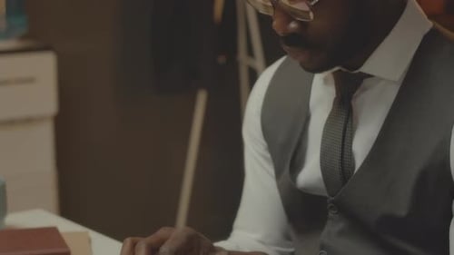 African American Detective Working on Computer in Office