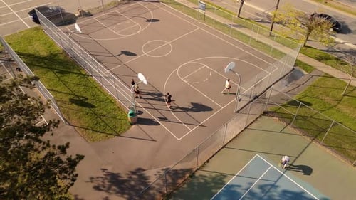 Aerial View Group of Street Basketball Players Playing Hard on the Court