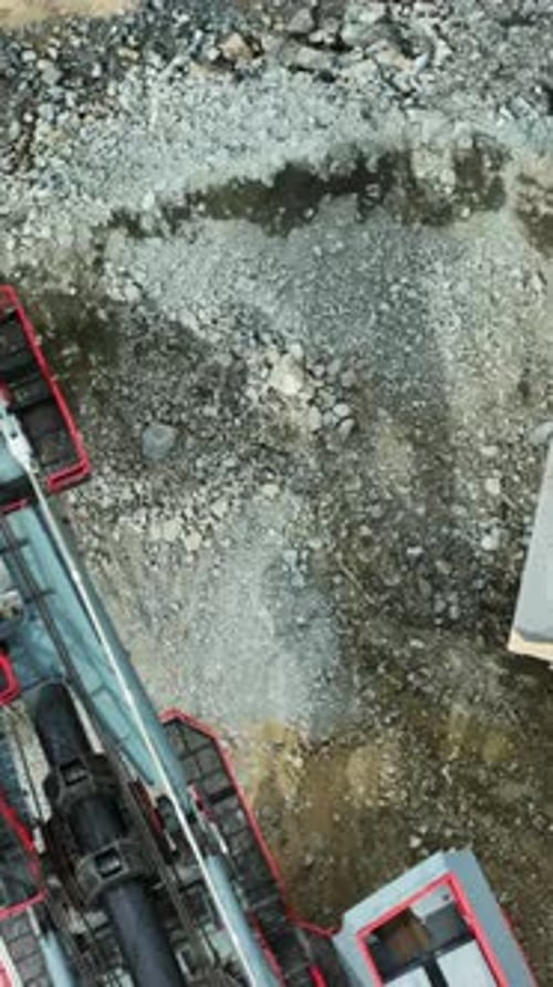 Drone footage of industrial machinery in a rock quarry