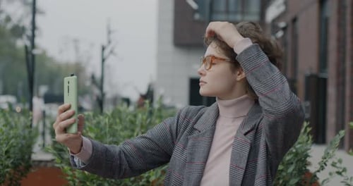 Slow Motion of Cheerful Young Woman Taking Selfie Posing for Smartphone Camera Having Fun in City