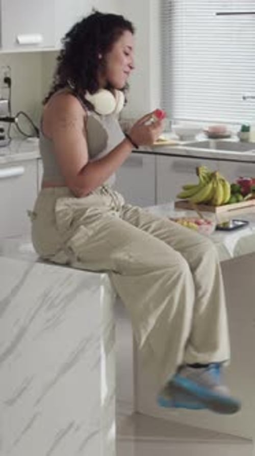 Young Water Eating Watermelon on Kitchen Counter