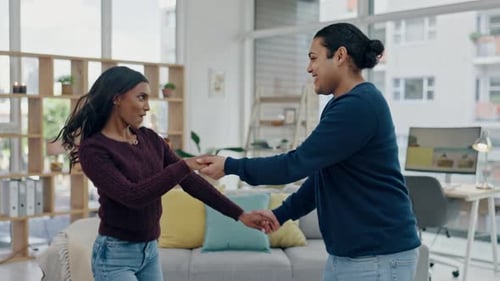 Happy Young Couple Dancing Together in Living Room