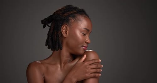 Shoulder, skincare and profile of black woman in studio for beauty, body care and clear skin glow
