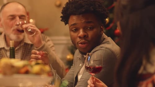 Family Celebrates Christmas with Dinner and Wine