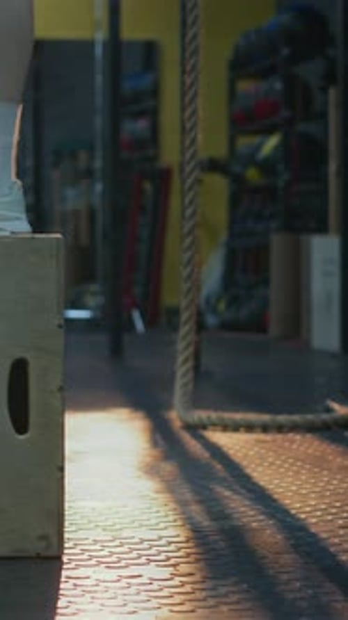 Legs of Unrecognisable Woman Doing Box Jumps in Gym