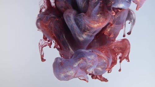 Colorful Nacreous Paint in Water Against White Background