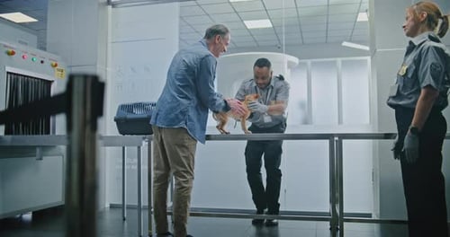 Airport Terminal TSA Officer Examining Dog Pet Inspection at Security Checkpoint