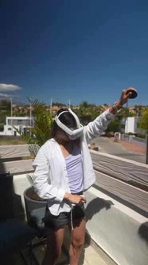 Woman Using Virtual Reality Headset on Balcony