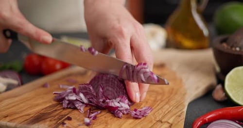 Chopping Red Onion on Cutting Board at Home
