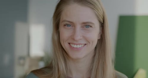 Woman Smiling Warmly at Camera in Close-Up