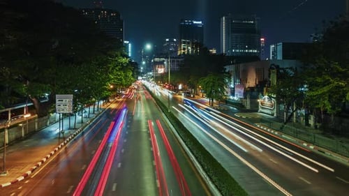 timelapse Nighttime Urban Traffic Flow with Light Trails in a Bustling City