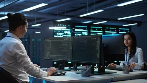 IT Specialist Provides Technical Support in Server Room During Network Monitoring